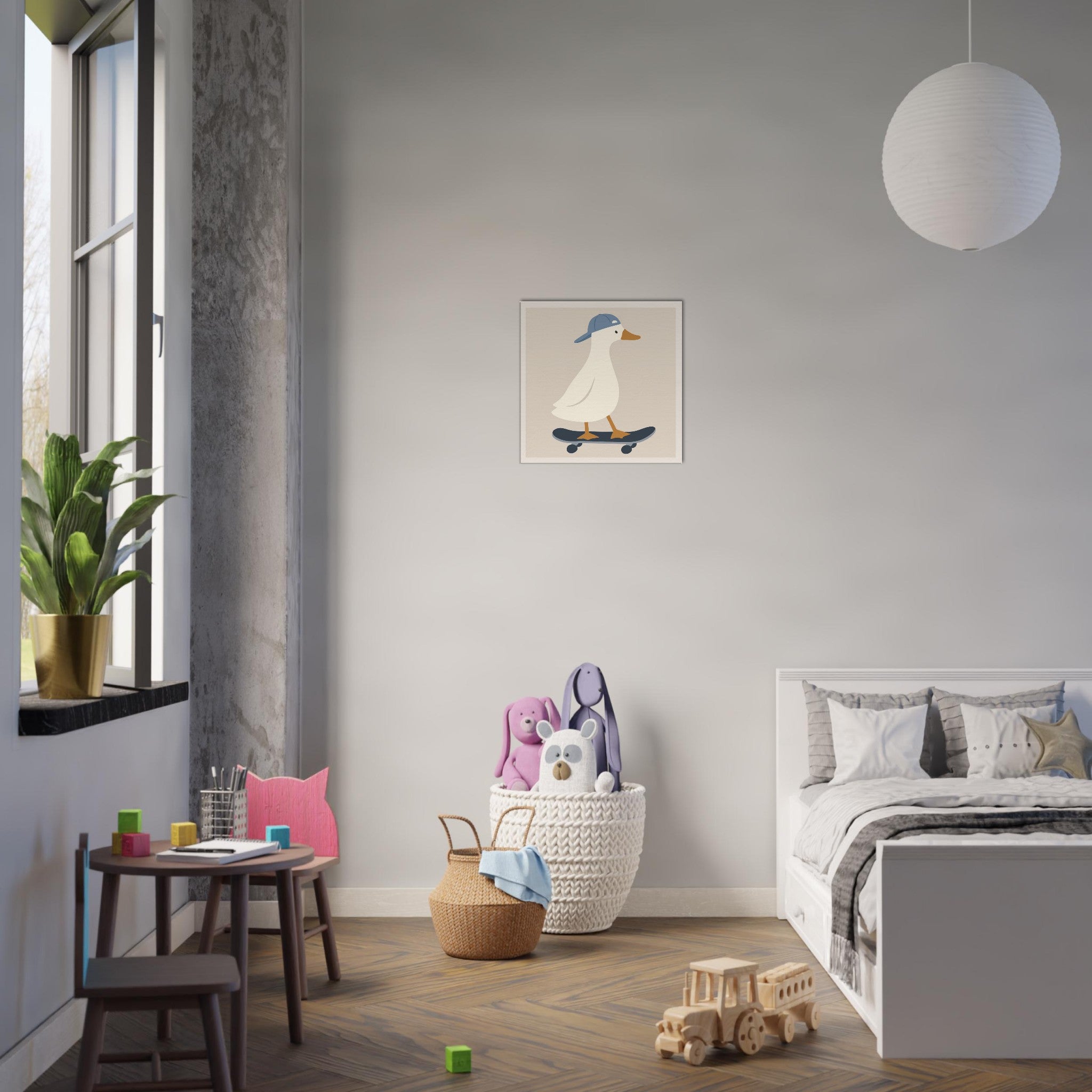 A styled children's bedroom featuring a small framed art print of a cartoon duck on a skateboard on the wall. The room includes a white bed, a small wooden table with a pink chair, a potted plant by the window, and a white paper globe pendant light.