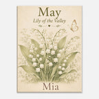 A personalized art print featuring a vintage-style botanical illustration of a lily of the valley bouquet with a butterfly, on a warm cream background. The text reads 'May Lily of the Valley' at the top and 'Mia' at the bottom.