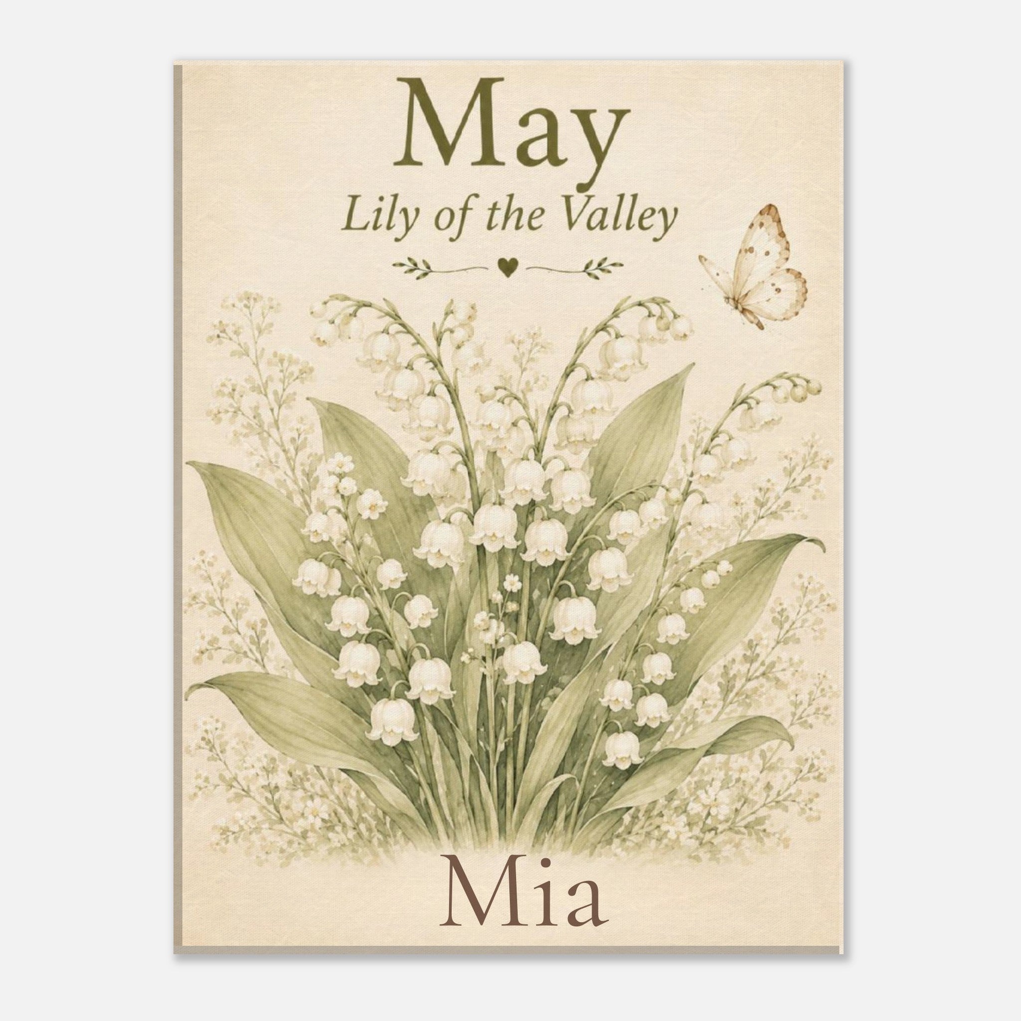 A personalized art print featuring a vintage-style botanical illustration of a lily of the valley bouquet with a butterfly, on a warm cream background. The text reads 'May Lily of the Valley' at the top and 'Mia' at the bottom.