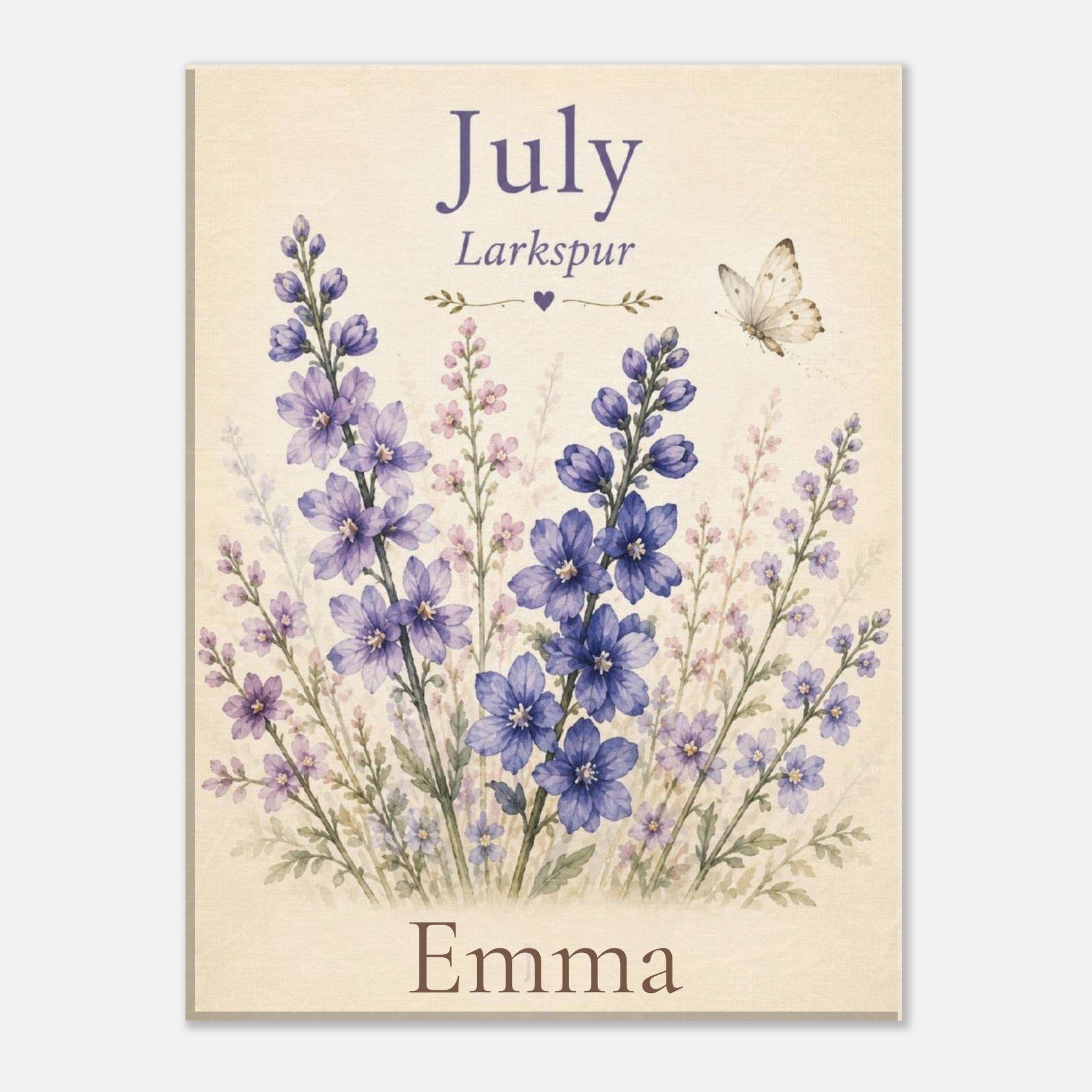 A personalized floral art print featuring purple larkspur flowers on a cream background, with the text 'July', 'Larkspur', and 'Emma' printed on the design.