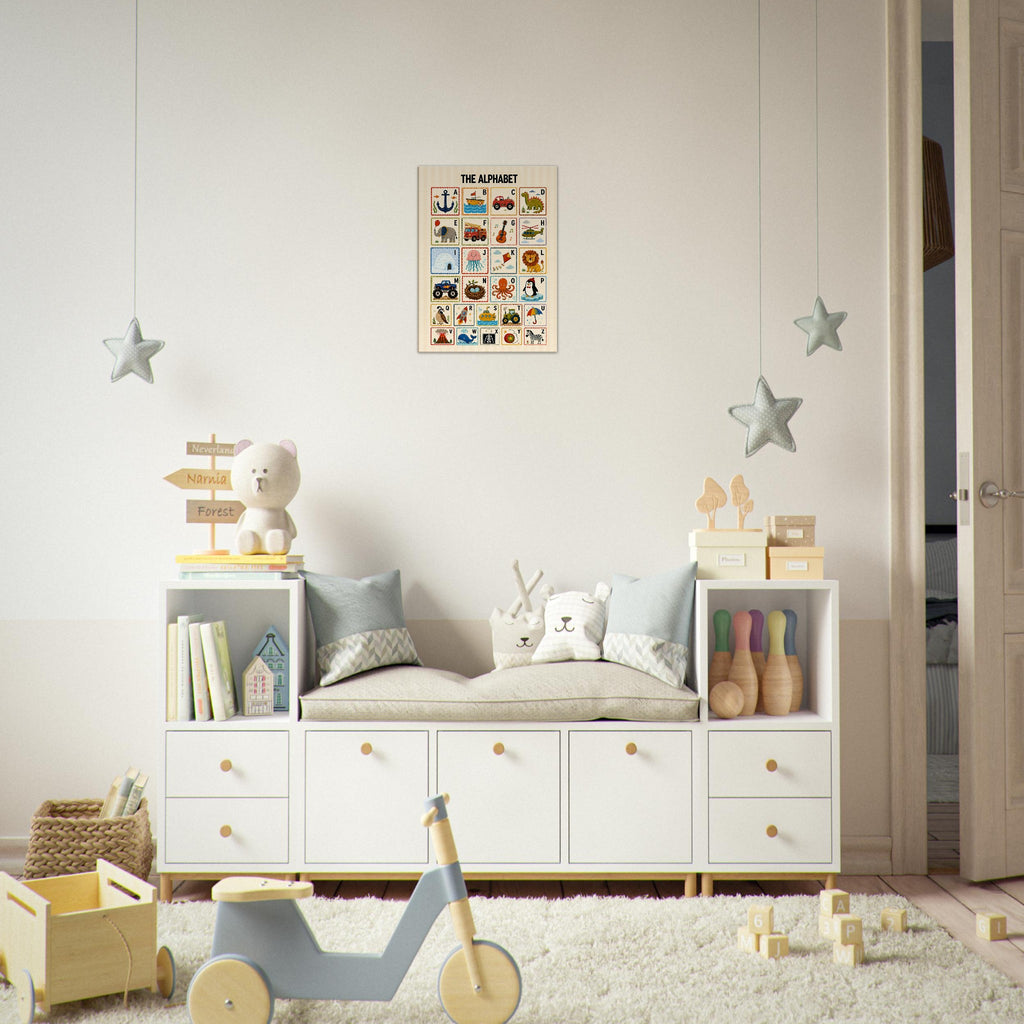 A styled children's room corner featuring a white wooden storage bench with cubbies and drawers, styled with toys, pillows, and books, with a colorful alphabet poster hanging on the wall above.