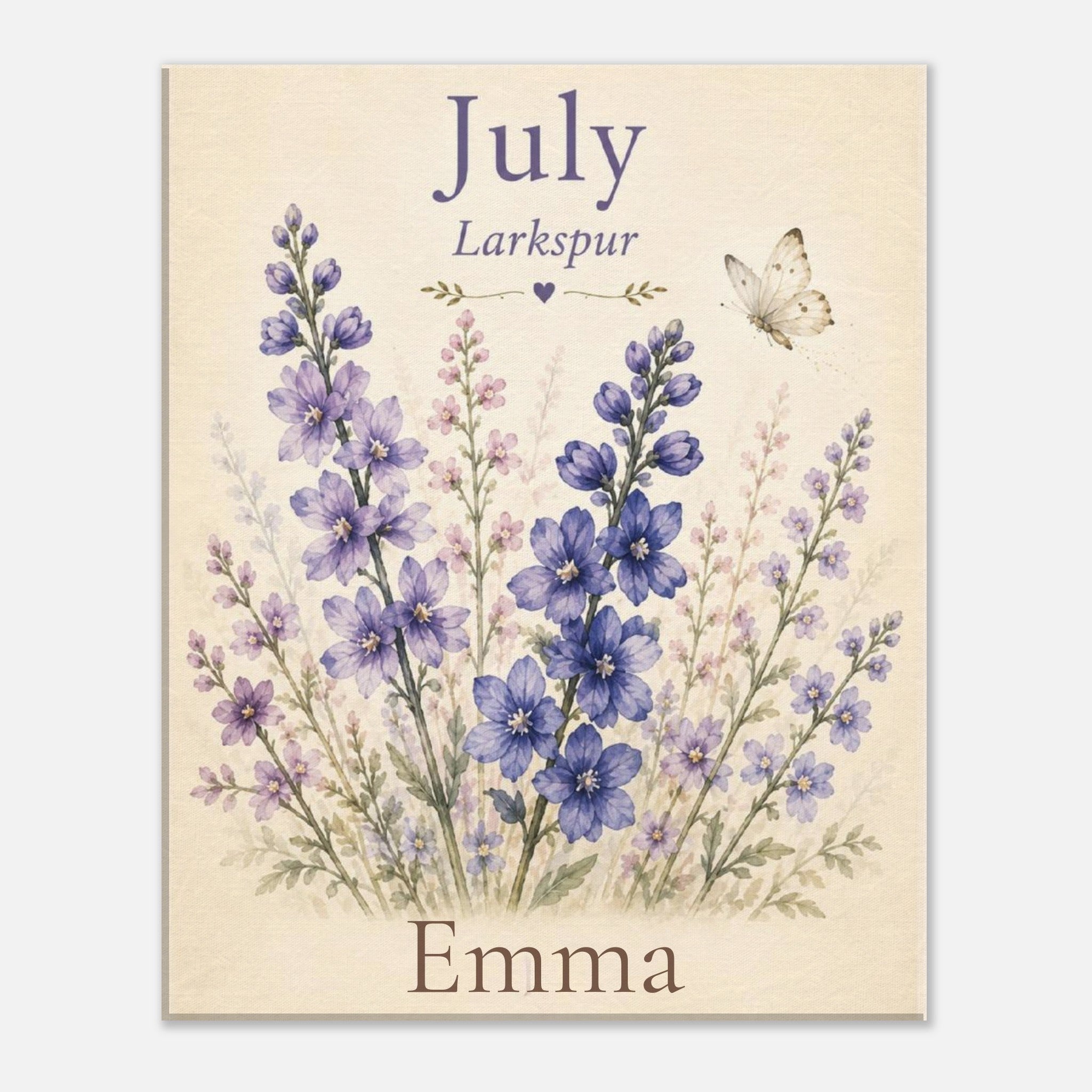 A personalized floral print featuring blue and purple wildflowers on a warm cream background, with the text 'July', 'Larkspur', and 'Emma' arranged around the bouquet, plus a small butterfly illustration.