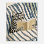 A square art print or poster showing a painted tabby cat reading a book on a blue-and-cream striped surface, centered on a light gray background.