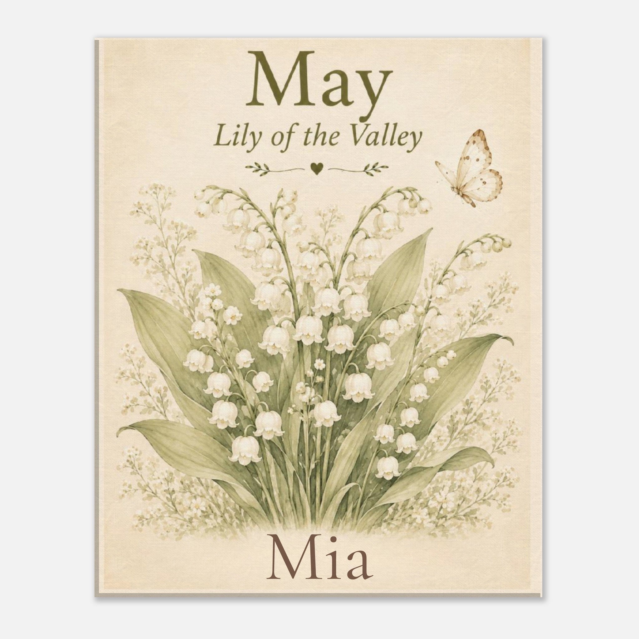 A personalized botanical art print featuring lily of the valley flowers, green leaves, and a butterfly on a warm cream background, with the text 'May', 'Lily of the Valley', and 'Mia'.