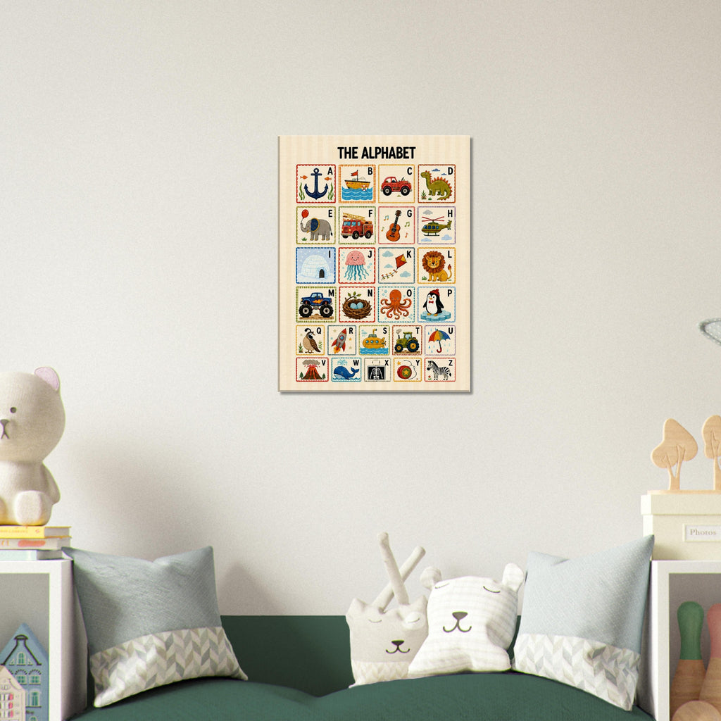 A framed alphabet poster hanging on a light gray wall above a green sofa with pillows in a styled room setting.