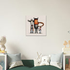 A framed wall art print featuring three whimsical animal-like figures in muted orange, gray, black, and white tones, displayed above a green sofa in a styled children's room.