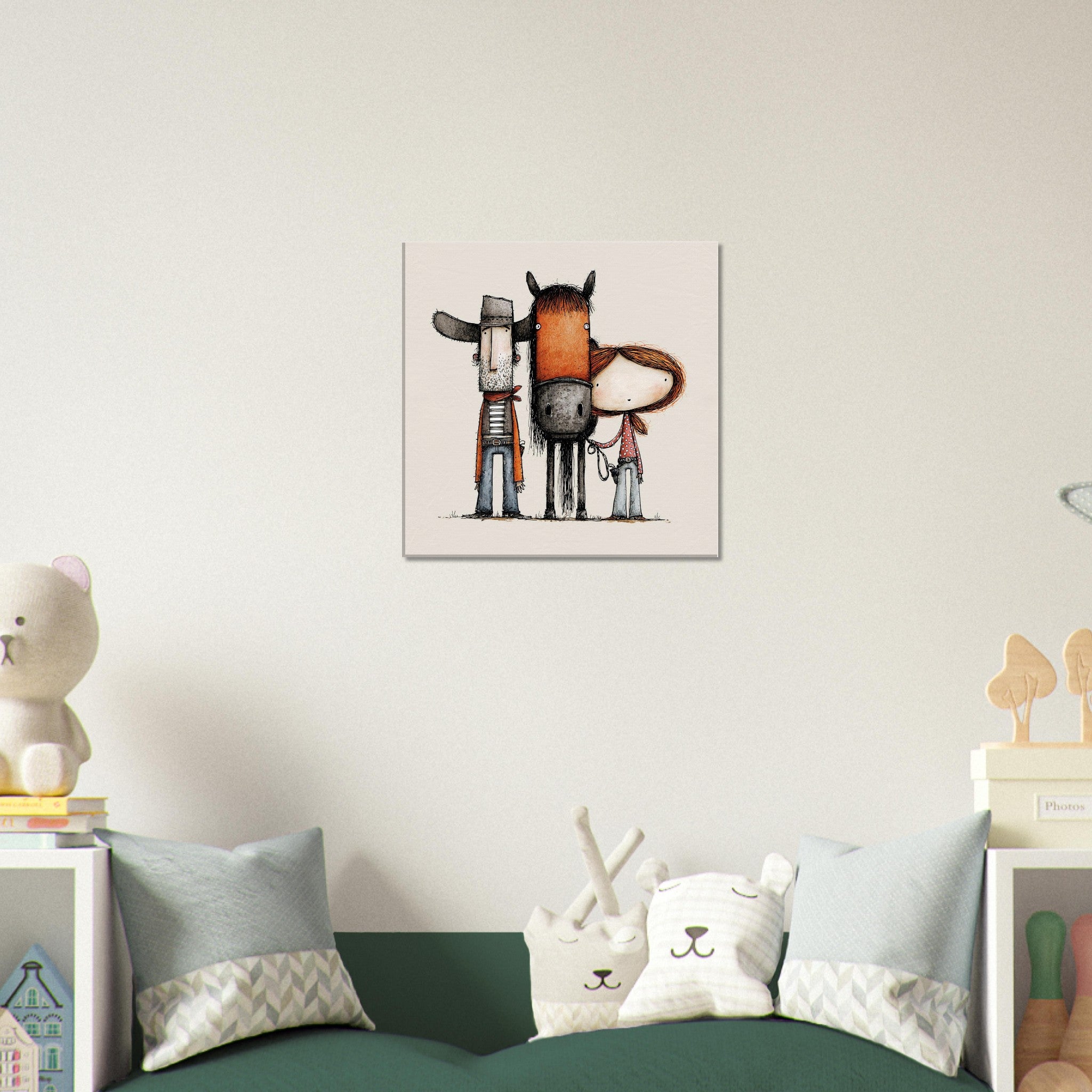 A framed wall art print featuring three whimsical animal-like figures in muted orange, gray, black, and white tones, displayed above a green sofa in a styled children's room.